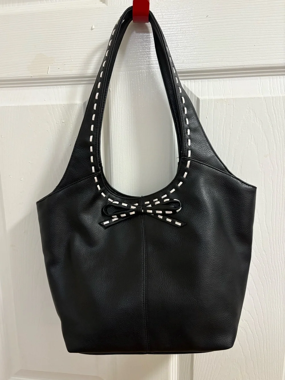 black hobo-style shoulder bag , measures 9 by 14 by 4 inches
